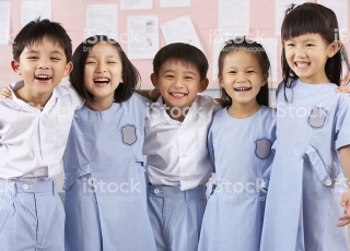 Portait Of Students In Chinese School Classroom Laughing At Camera